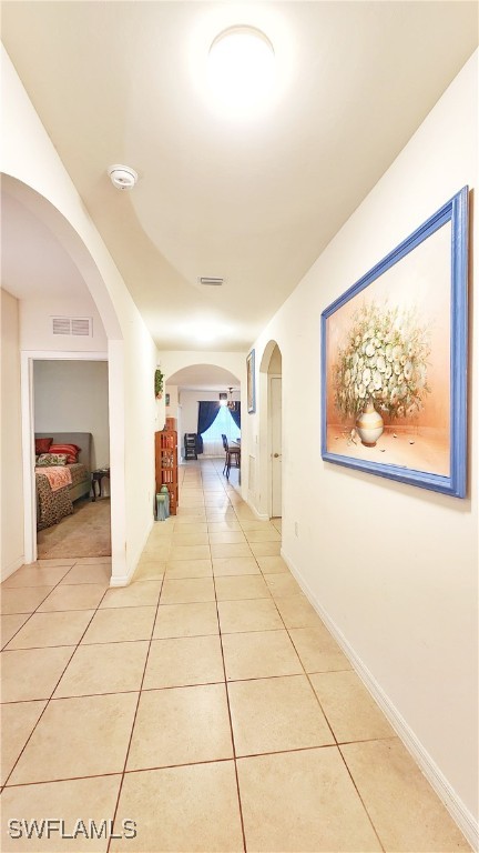 corridor featuring light tile patterned flooring