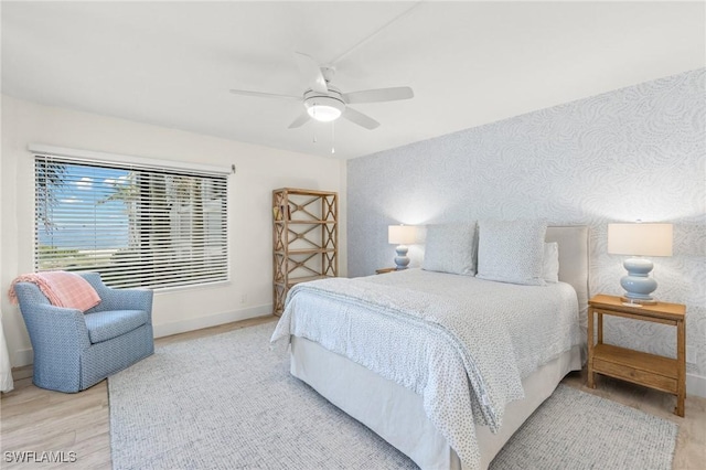 2777 W Gulf Dr Unit 109, Sanibel, FL 33957 - bedroom with baseboards, a ceiling fan, and wood finished floors
