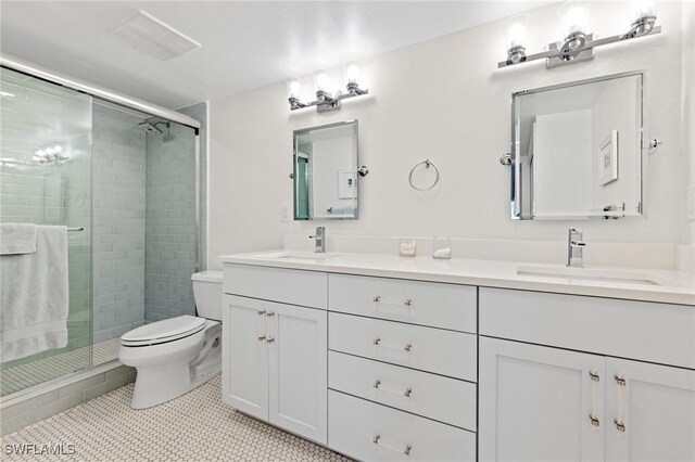 2777 W Gulf Dr Unit 109, Sanibel, FL 33957 - bathroom with double vanity, toilet, a shower stall, and tile patterned flooring