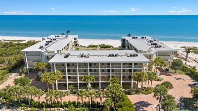 bird's eye view featuring a water view and a beach view