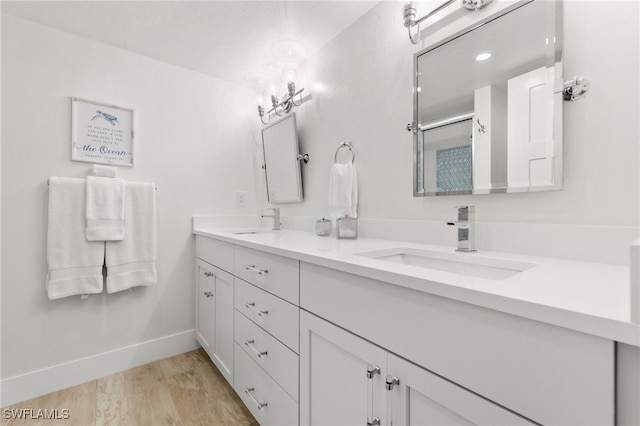 bathroom featuring vanity, hardwood / wood-style flooring, and walk in shower