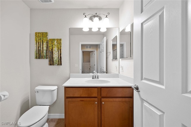 bathroom with vanity, toilet, and tile patterned floors