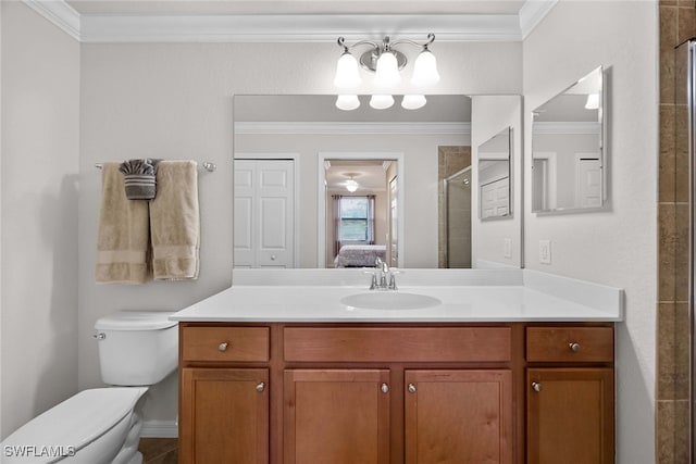 bathroom with ornamental molding, a shower with door, vanity, and toilet