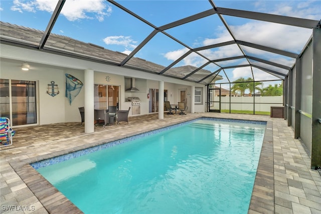 view of swimming pool with a lanai and a patio