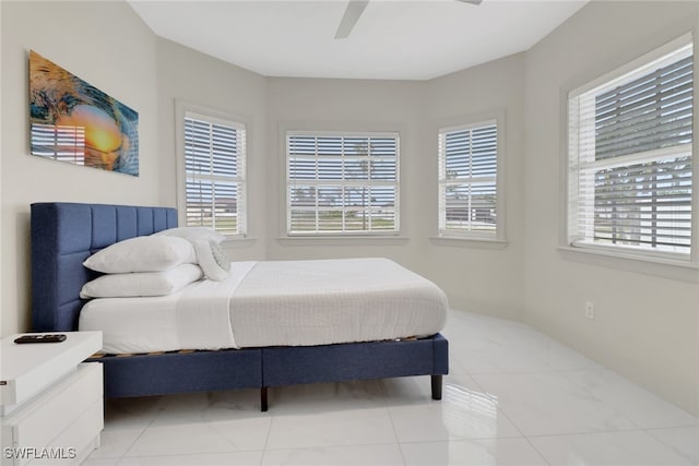 bedroom featuring light tile patterned floors and ceiling fan