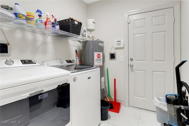 laundry room featuring water heater and washer and dryer