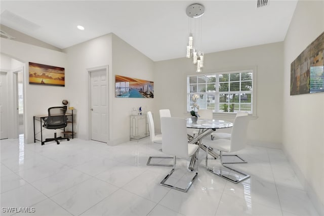 tiled dining space with vaulted ceiling