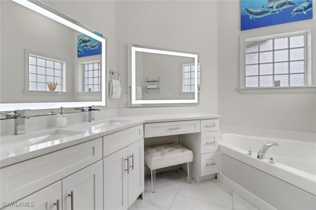 bathroom with a bath, a wealth of natural light, and vanity