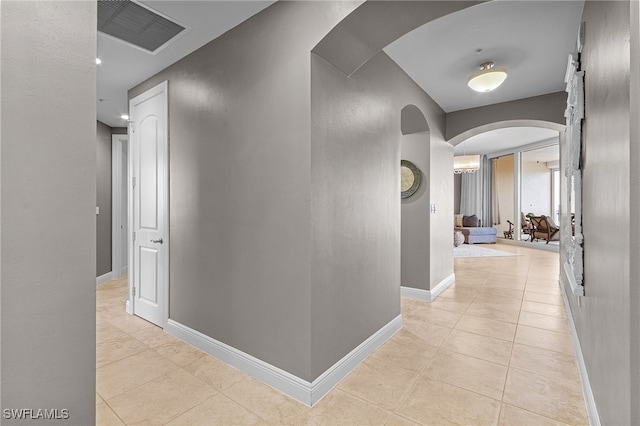 hall featuring light tile patterned floors