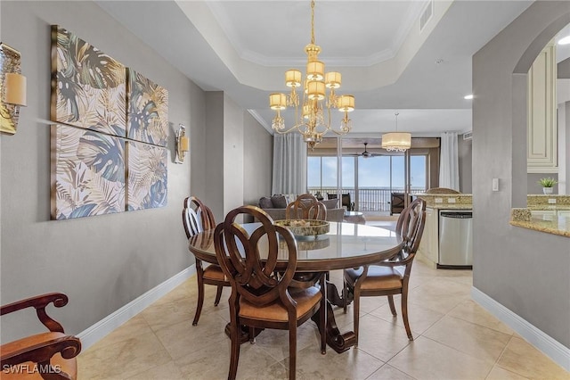2090 W First St Unit 2007, Fort Myers, FL 33901 - dining room with a tray ceiling, light tile patterned floors, baseboards, and arched walkways