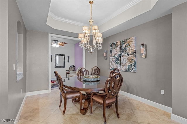 tiled dining room featuring ornamental molding, a raised ceiling, and a notable chandelier