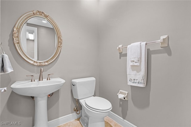 bathroom featuring tile patterned flooring and toilet