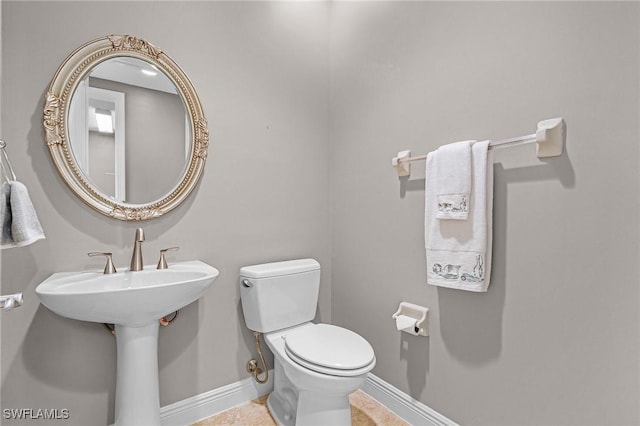 2090 W First St Unit 2007, Fort Myers, FL 33901 - bathroom with toilet, baseboards, and a sink