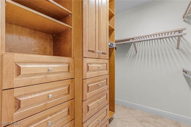 walk in closet featuring light tile patterned floors