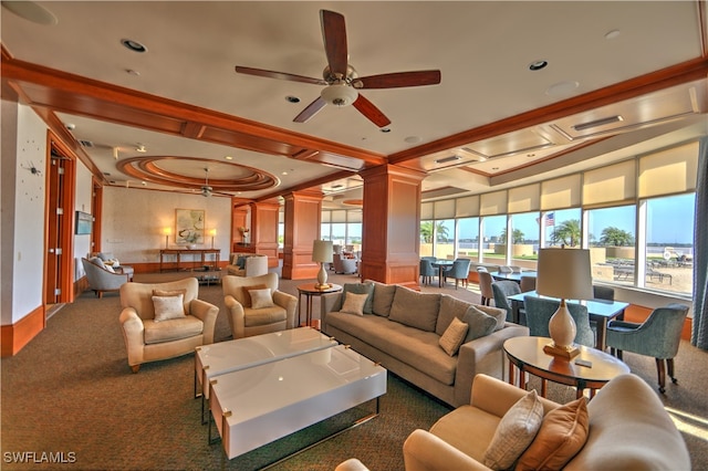 carpeted living room featuring ceiling fan, crown molding, and ornate columns