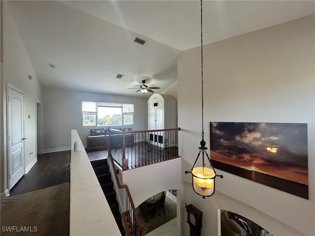 staircase with vaulted ceiling, wood-type flooring, and ceiling fan