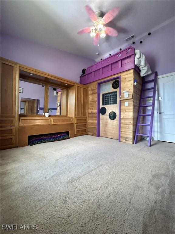 unfurnished living room with carpet floors and ceiling fan