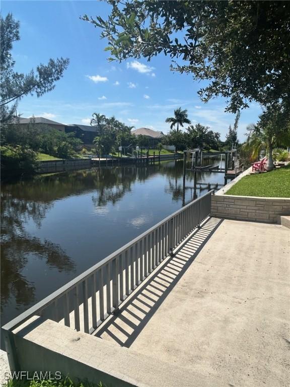 exterior space featuring a boat dock and a water view