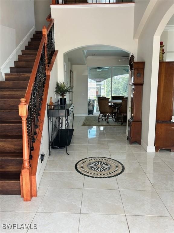 entryway with tile patterned flooring and a high ceiling