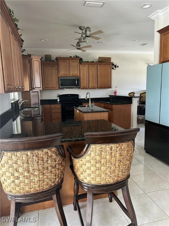 kitchen featuring sink, crown molding, light tile patterned floors, black / electric stove, and kitchen peninsula