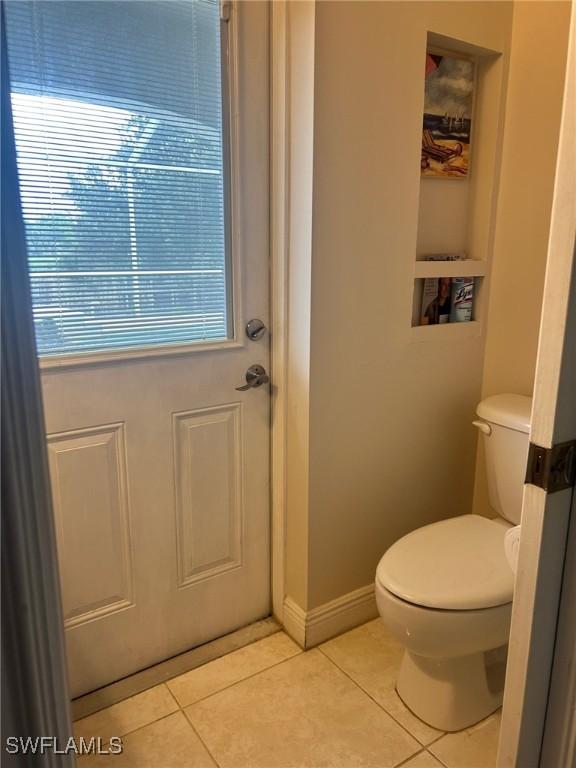 bathroom featuring tile patterned flooring and toilet