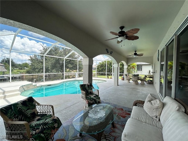 view of pool with a lanai, a patio area, and ceiling fan