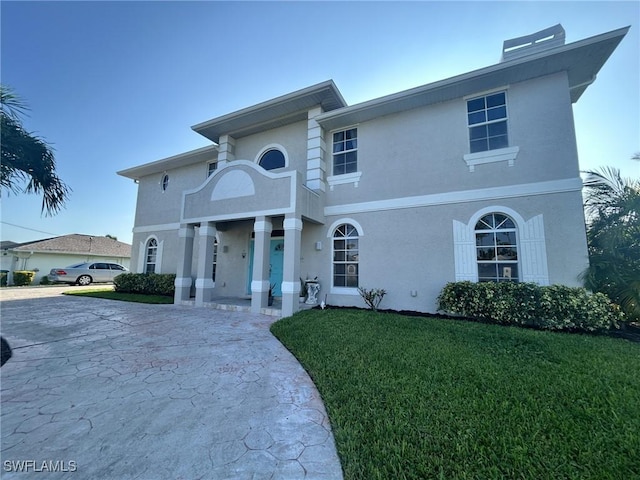 view of front facade featuring a front yard and stucco siding