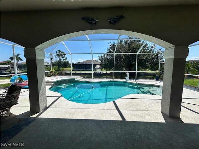 pool featuring glass enclosure and a patio