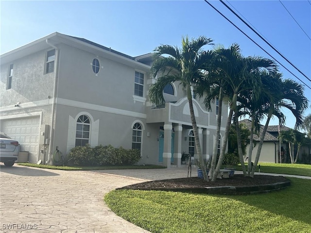 view of front of home with a front yard and stucco siding