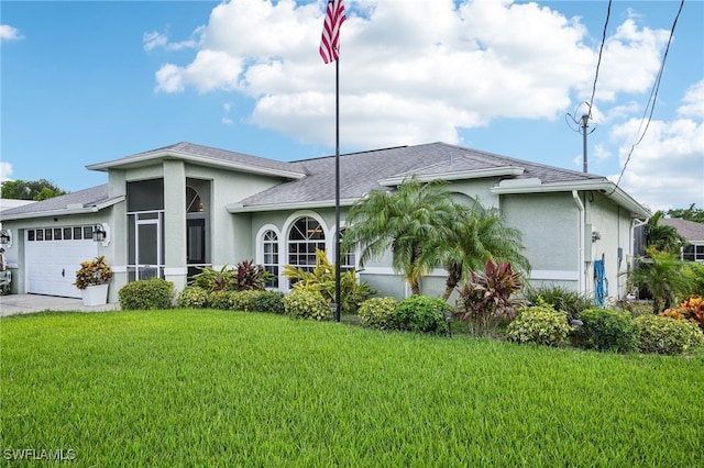 view of front of house with a front yard and a garage