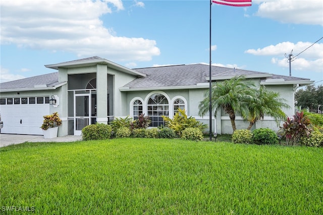 view of front of house featuring a front lawn and a garage