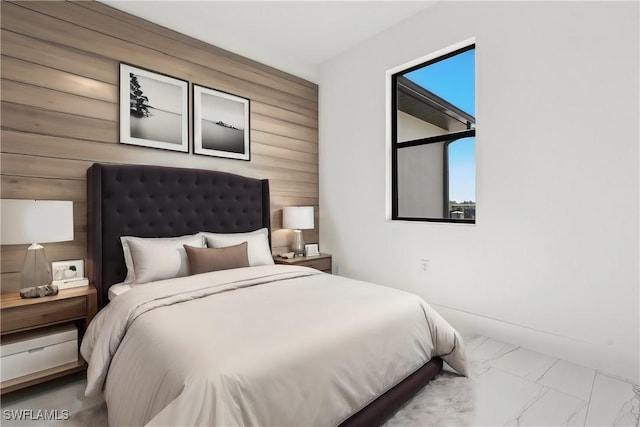 bedroom featuring wooden walls