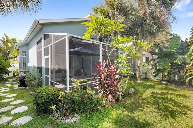 view of side of home with a yard