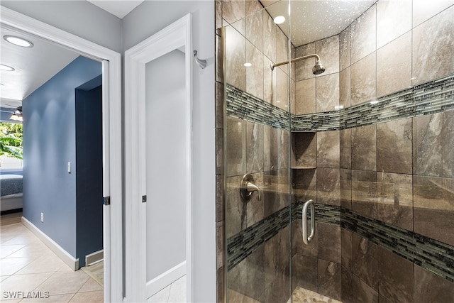 bathroom featuring a shower with shower door and tile patterned floors