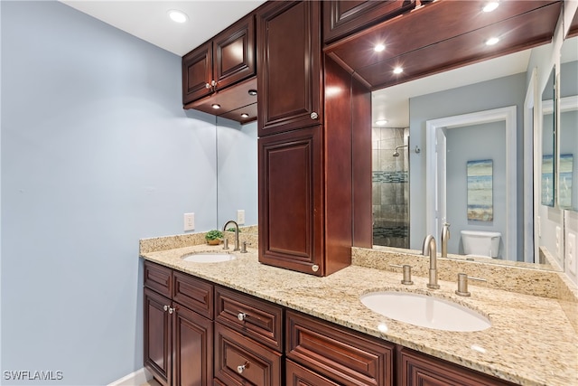 bathroom featuring walk in shower, vanity, and toilet