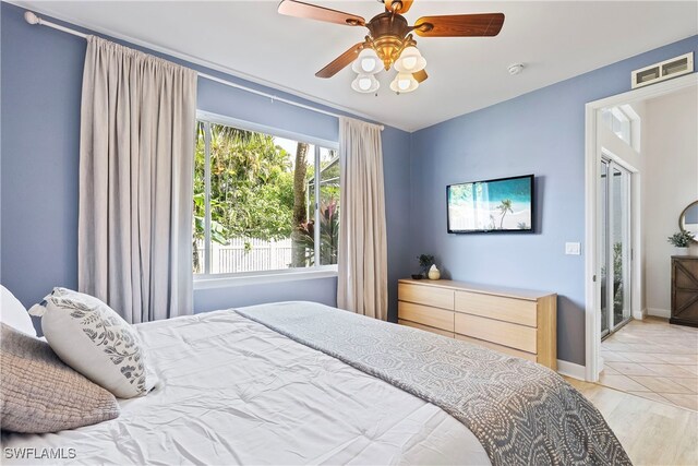 bedroom with ceiling fan and light hardwood / wood-style flooring