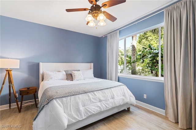 bedroom with ceiling fan and light hardwood / wood-style flooring