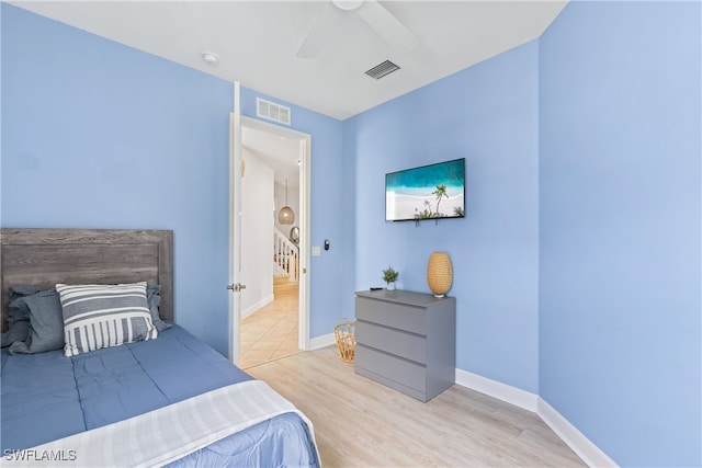 bedroom with ceiling fan and light hardwood / wood-style flooring