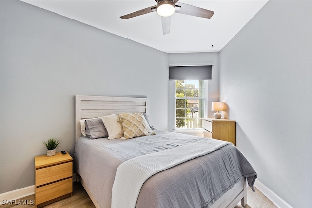 bedroom with light hardwood / wood-style flooring and ceiling fan