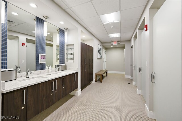 bathroom with a drop ceiling and vanity