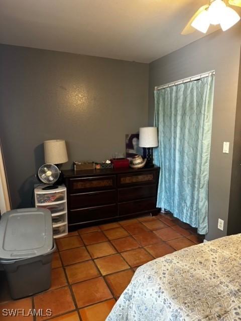 bedroom featuring ceiling fan and tile patterned flooring