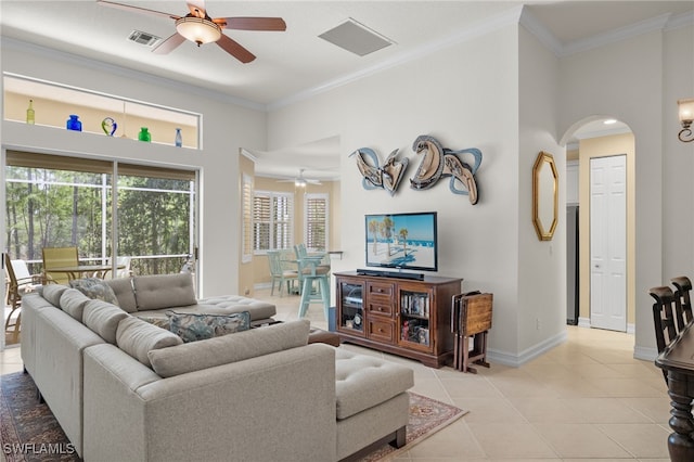 tiled living room featuring ceiling fan and ornamental molding