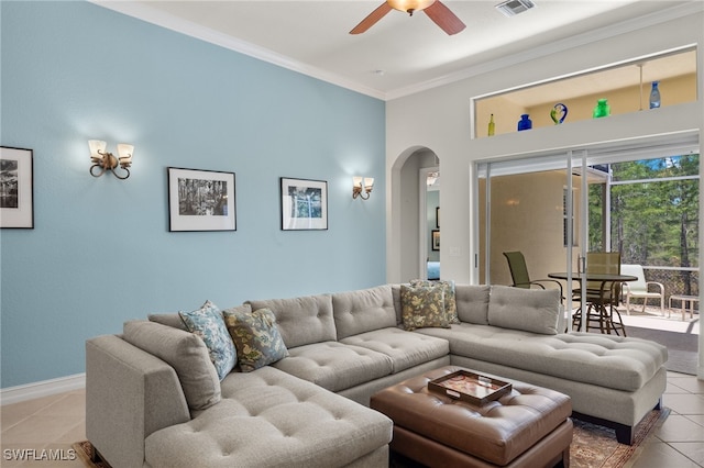 tiled living room with ornamental molding and ceiling fan