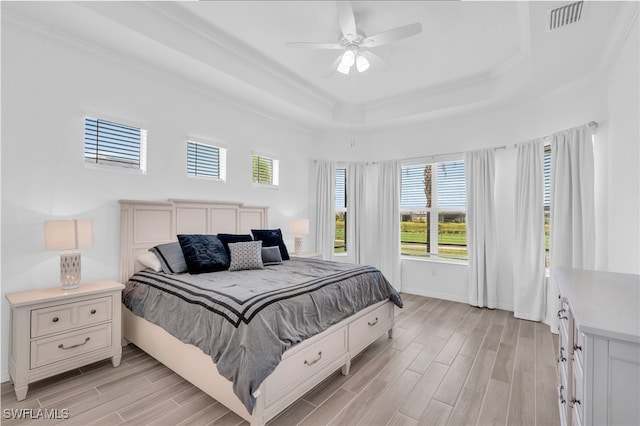 bedroom featuring light wood-type flooring, multiple windows, and ceiling fan