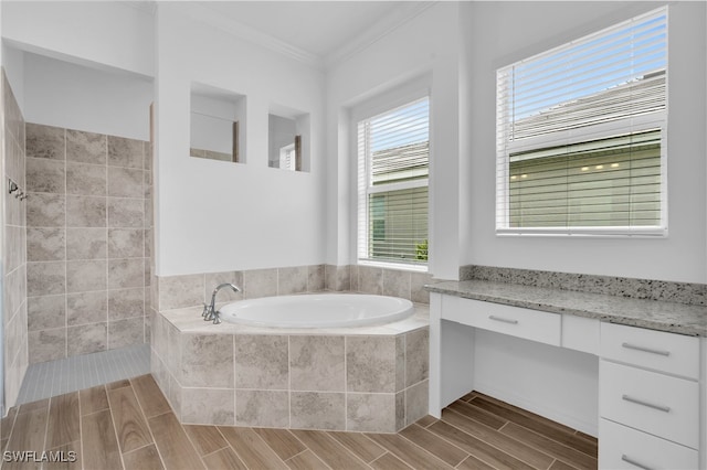 bathroom with wood-type flooring, a wealth of natural light, ornamental molding, and vanity