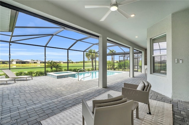 view of pool featuring a lanai, ceiling fan, a patio, and an in ground hot tub