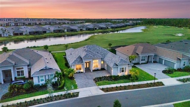 aerial view at dusk with a water view