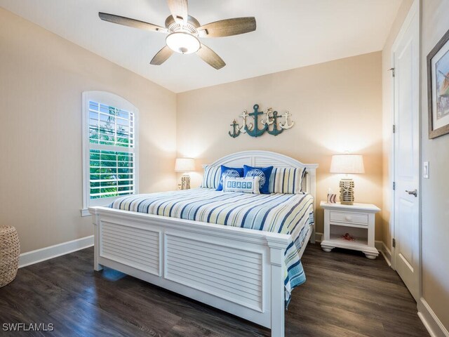 bedroom with ceiling fan and dark hardwood / wood-style flooring