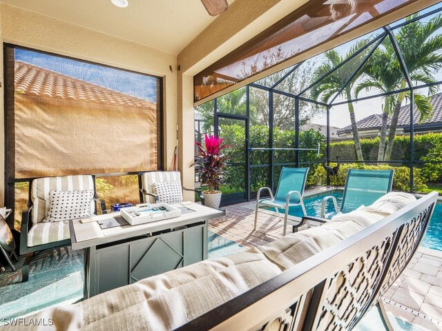 view of patio / terrace with pool water feature and an outdoor living space with a fire pit