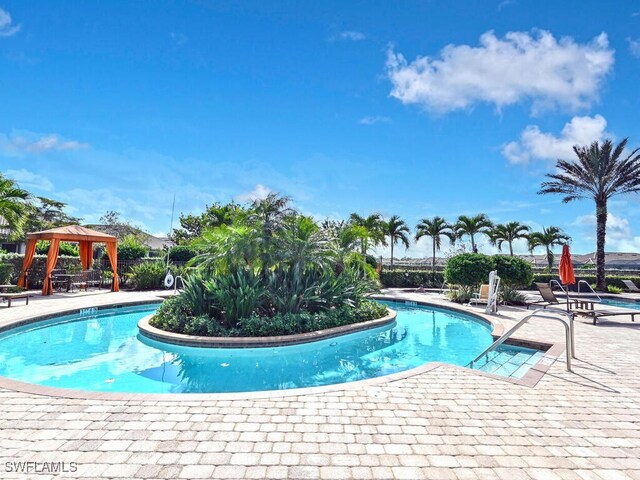 view of swimming pool with a gazebo and a patio area